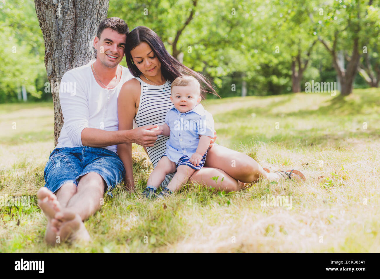 Happy Family Having fun with baby playing In The Park. Stock Photo