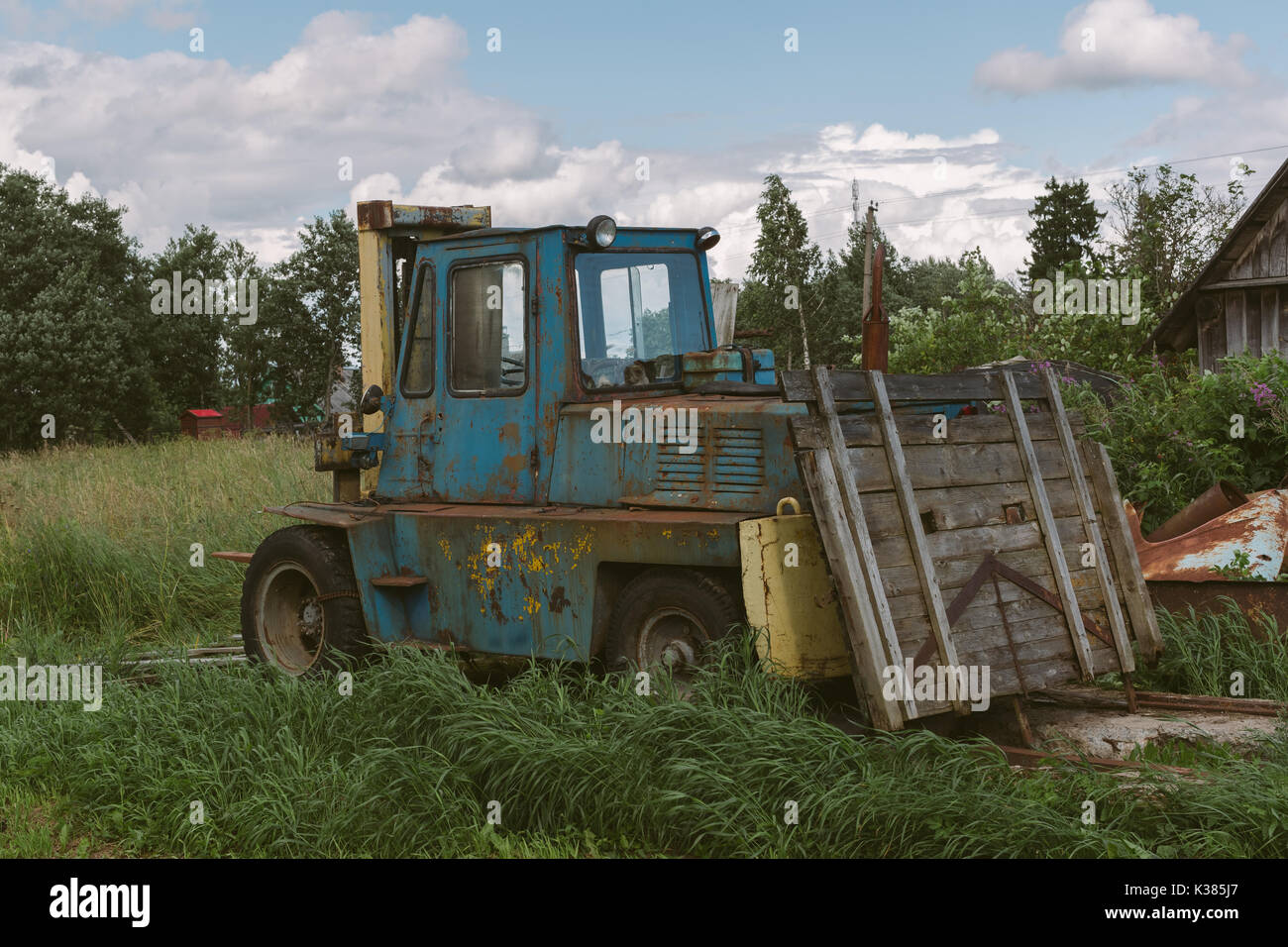 Old loader car in a green yard. Stock Photo