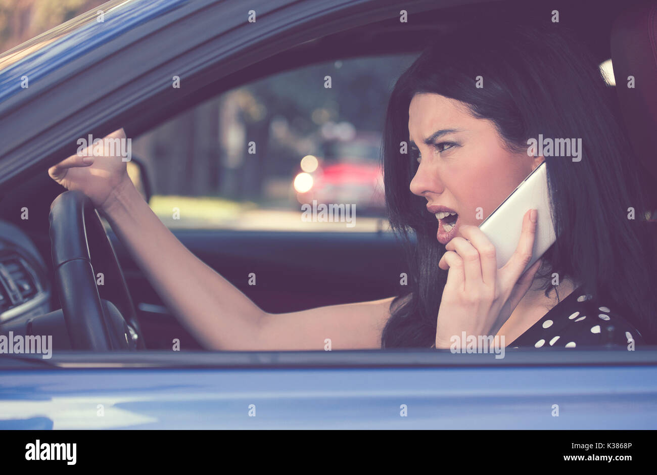 Side profile angry driver woman talking on mobile phone. Negative human emotions face expression Stock Photo