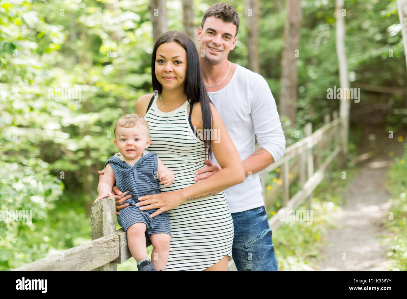 Happy Family Having fun with baby playing In The Park Stock Photo - Alamy