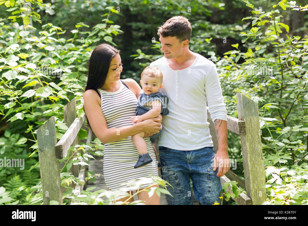 Happy Family Having fun with baby playing In The Park Stock Photo - Alamy