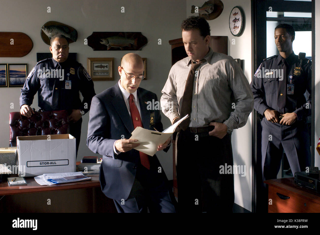 THE TERMINAL l to r, BARRY SHABAKA HENLEY, STANLEY TUCCI, TOM HANKS AND COREY REYNOLDS SUBJECT: AIRPORTS, IMMIGRATION     Date: 2004 Stock Photo