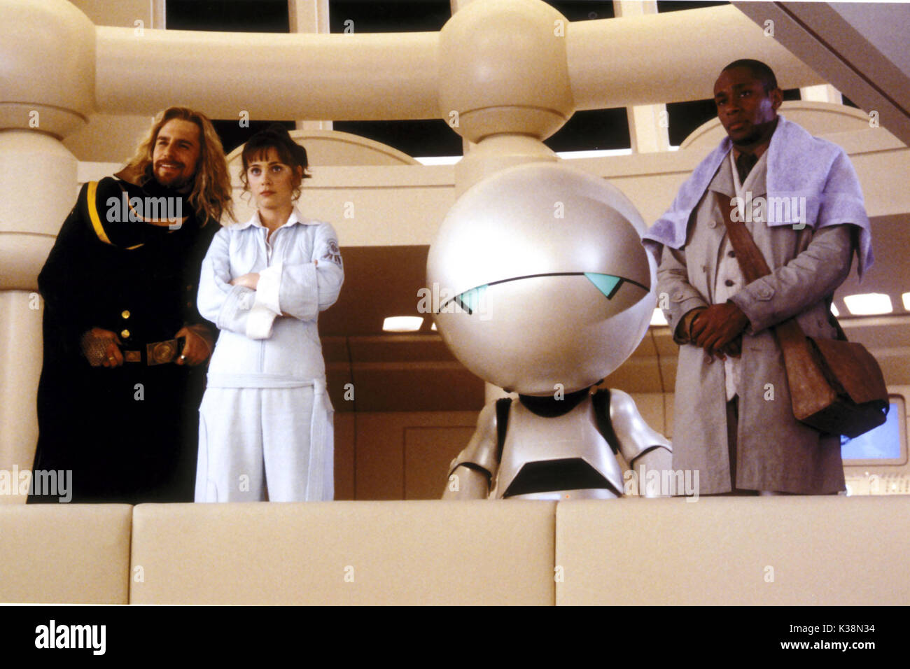 THE HITCHHIKER'S GUIDE TO THE GALAXY [US / BR 2005]  SAM ROCKWELL, as Zaphod Beeblebrox,  ZOOEY DESCHANEL, as Trillian,  [robot] Marvin, voiced by ALAN RICKMAN,  MOS DEF, as Ford Prefect     Date: 2005 Stock Photo