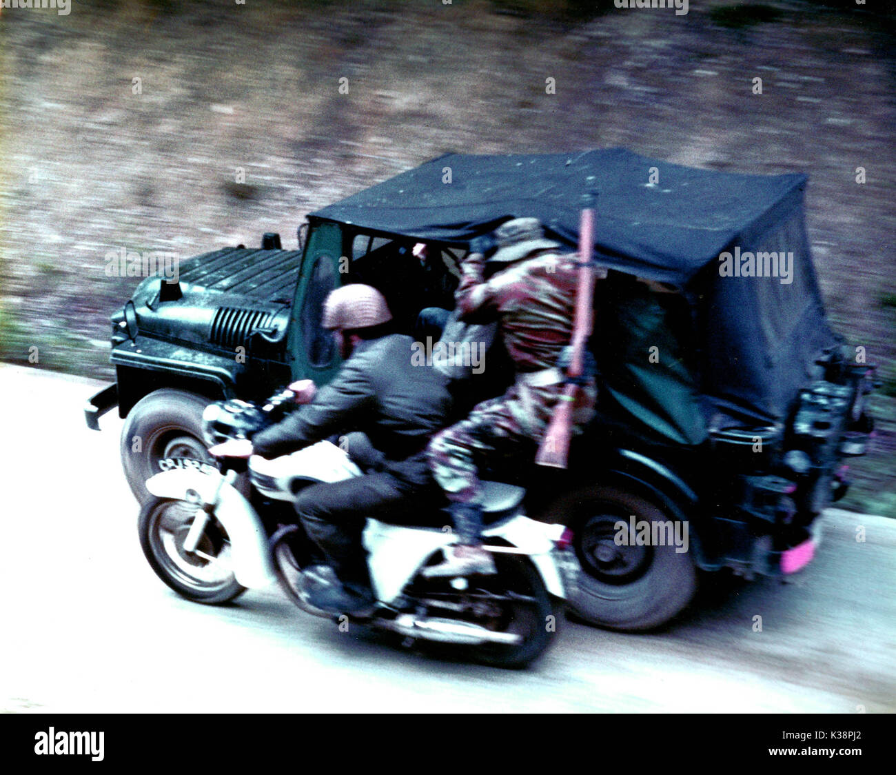 A stunt artiste making the dangerous move from the motor-cycle to the jeep from an unidentified production Stock Photo