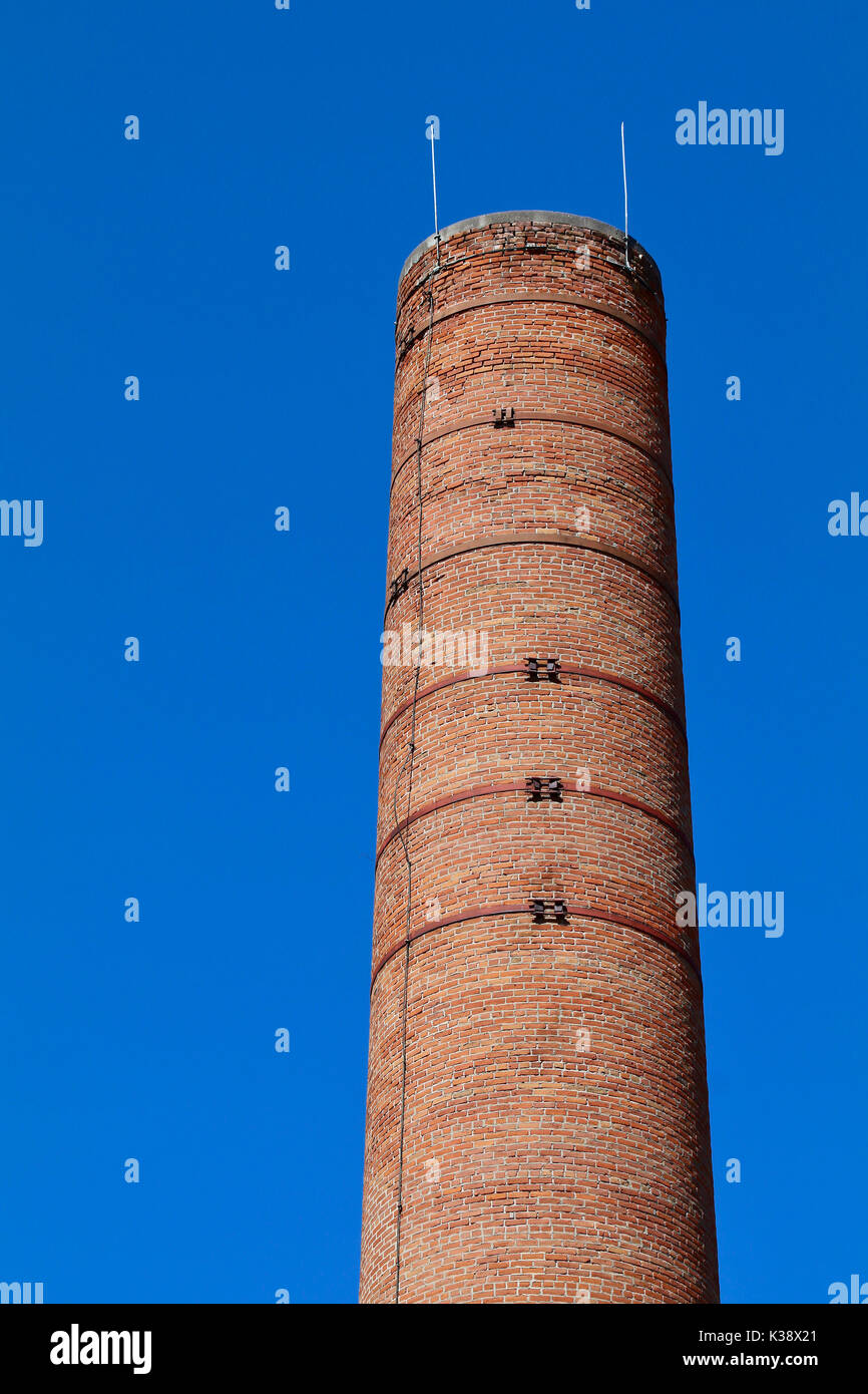 Flour mill red brick smokestack against the blue sky Stock Photo