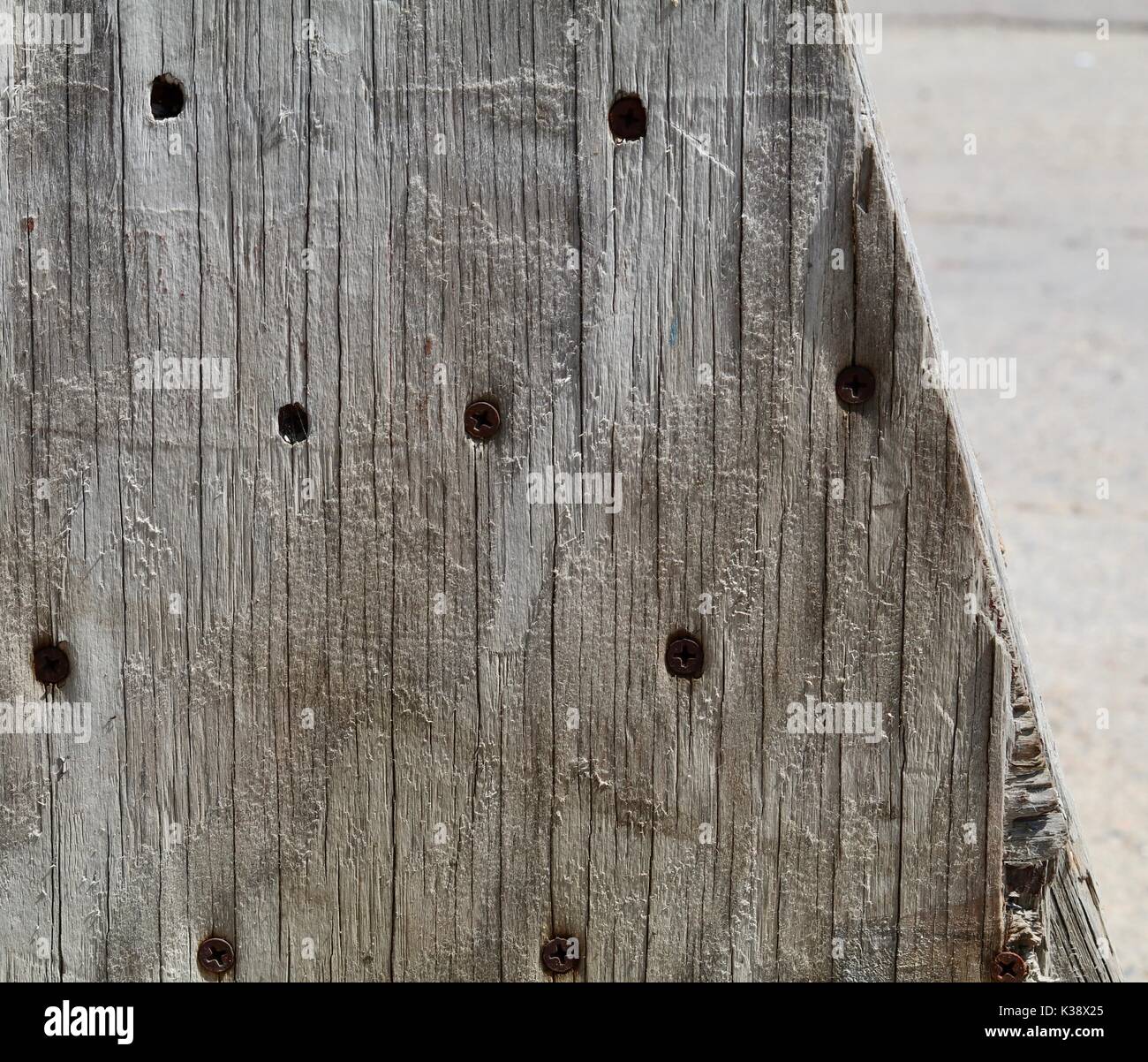 Old grey wood with dark screws showing Stock Photo