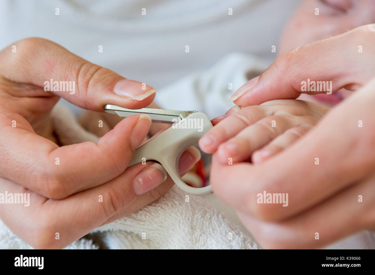 Mother gently cutting her baby nails Stock Photo - Alamy