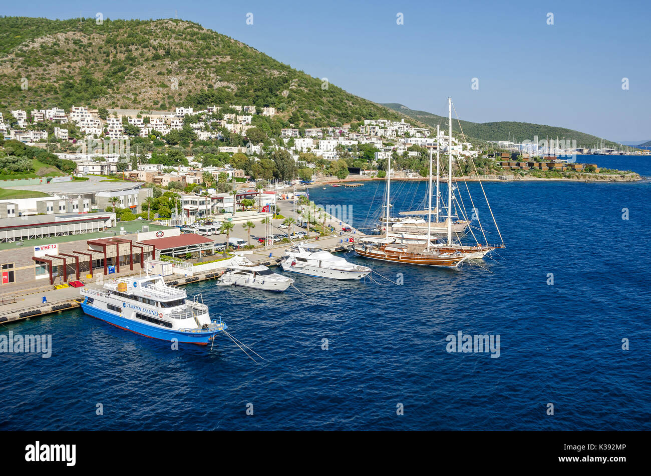Bodrum, Turkey - June 1, 2017:  White city of  Bodrum with the Gulet type schooners (a two-masted wooden sailing vessel), popular for tourist charters Stock Photo