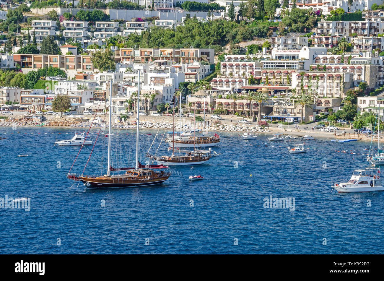 Bodrum, Turkey - June 1, 2017:  View of the white city of  Bodrum from the sea with the Gulet type schooners (a two-masted wooden sailing vessel), pop Stock Photo