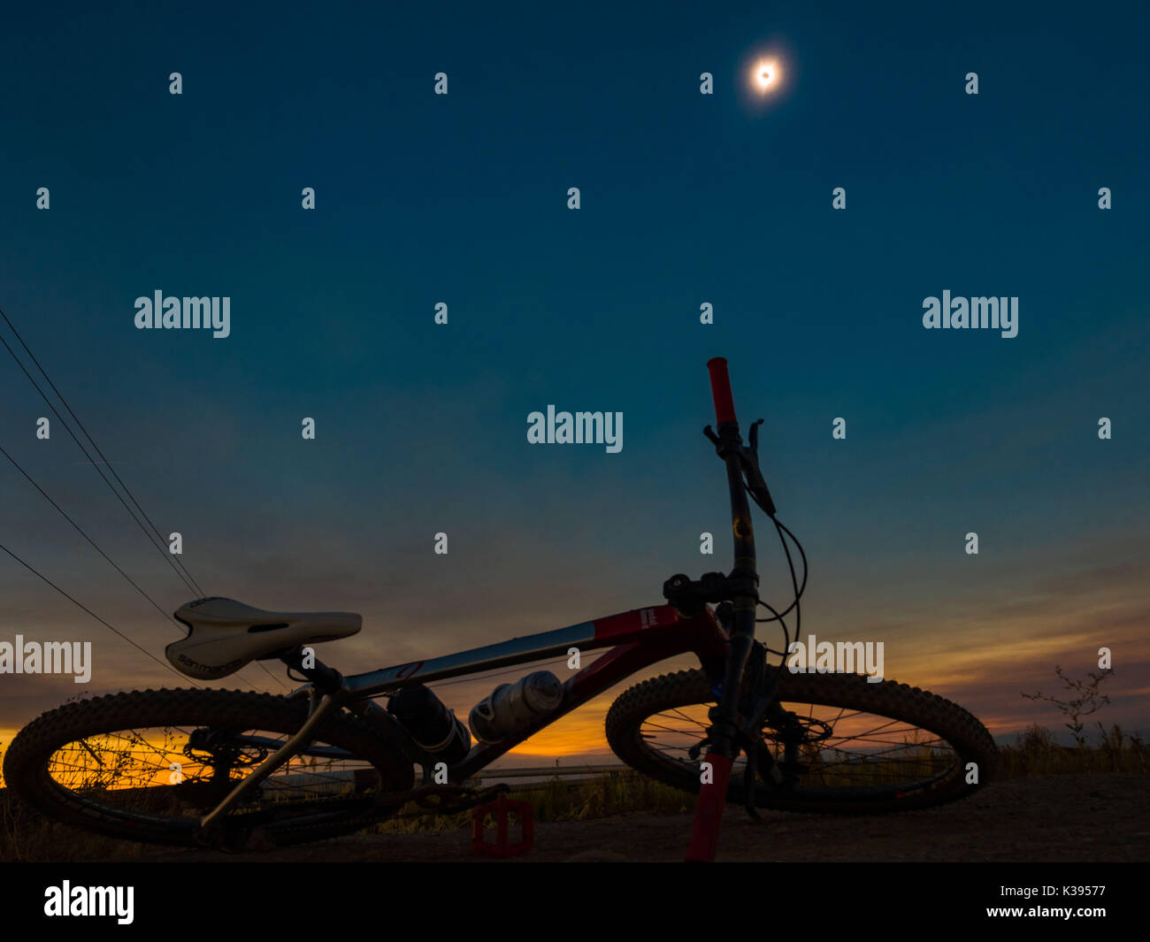 A bicycle is shown in the foreground during a total eclipse as seen from Madras, Oregon on August 21, 2017. Photo by Francis Specker Stock Photo
