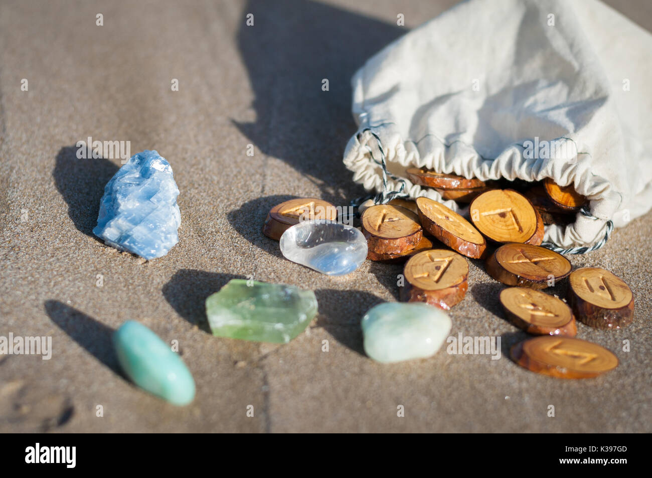 wood handmade runes and minerals on the sand Stock Photo - Alamy