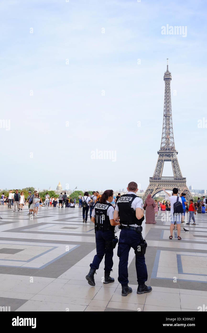 Armed French police patrol the streets of Paris and the Eiffel Tower in response to the terror alert in France, protecting tourist landmarks & sights Stock Photo