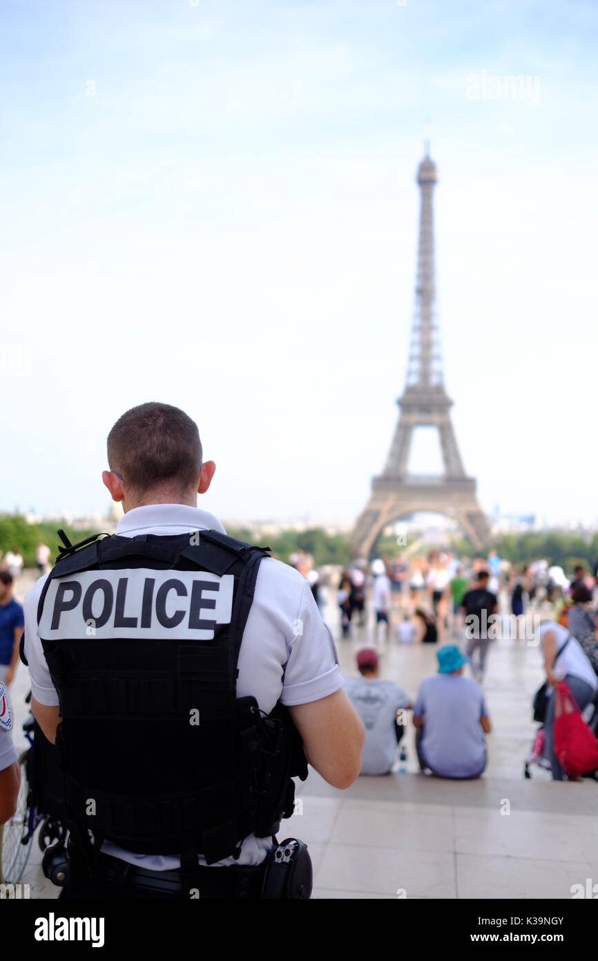 Armed French police patrol the streets of Paris and the Eiffel Tower in response to the terror alert in France, protecting tourist landmarks & sights Stock Photo
