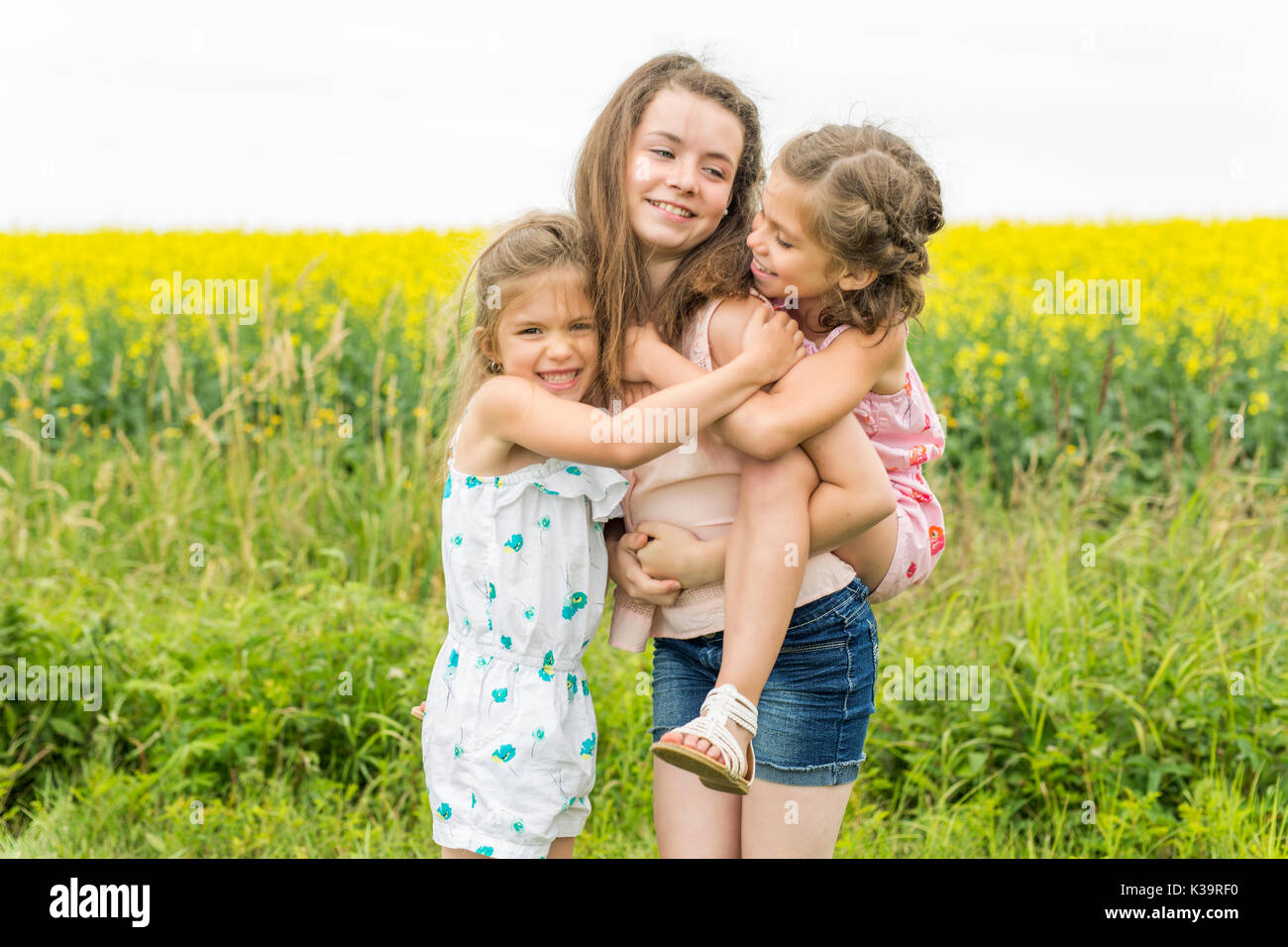 beautiful girls in a field of yellow flowers Stock Photo - Alamy