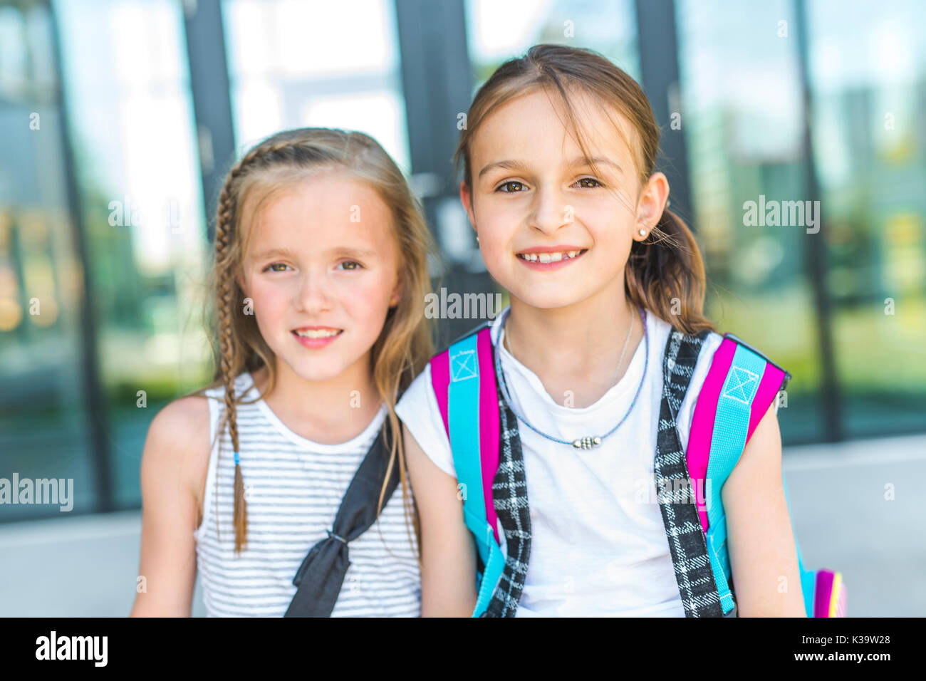 Two girls standing back to back hi-res stock photography and images - Alamy