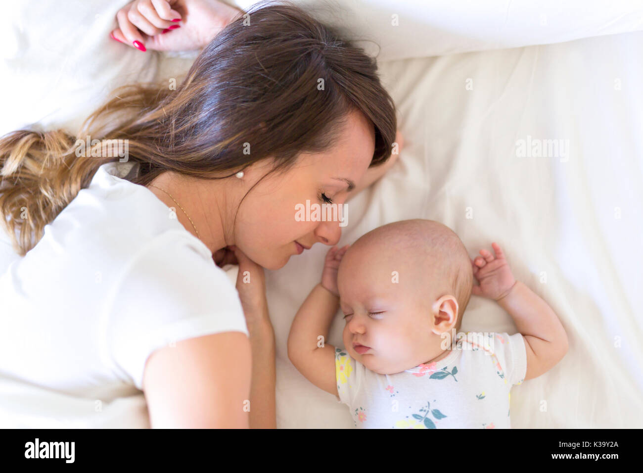 Portrait of mother with her 3 month old baby in bedroom Stock Photo Alamy