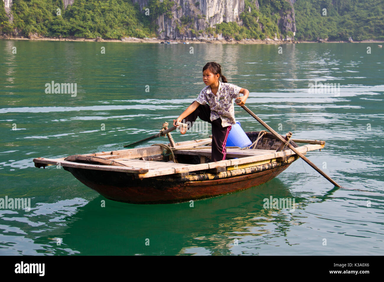 North Vietnamese girl rows boat across lake on Oct 23, 2011 Stock Photo