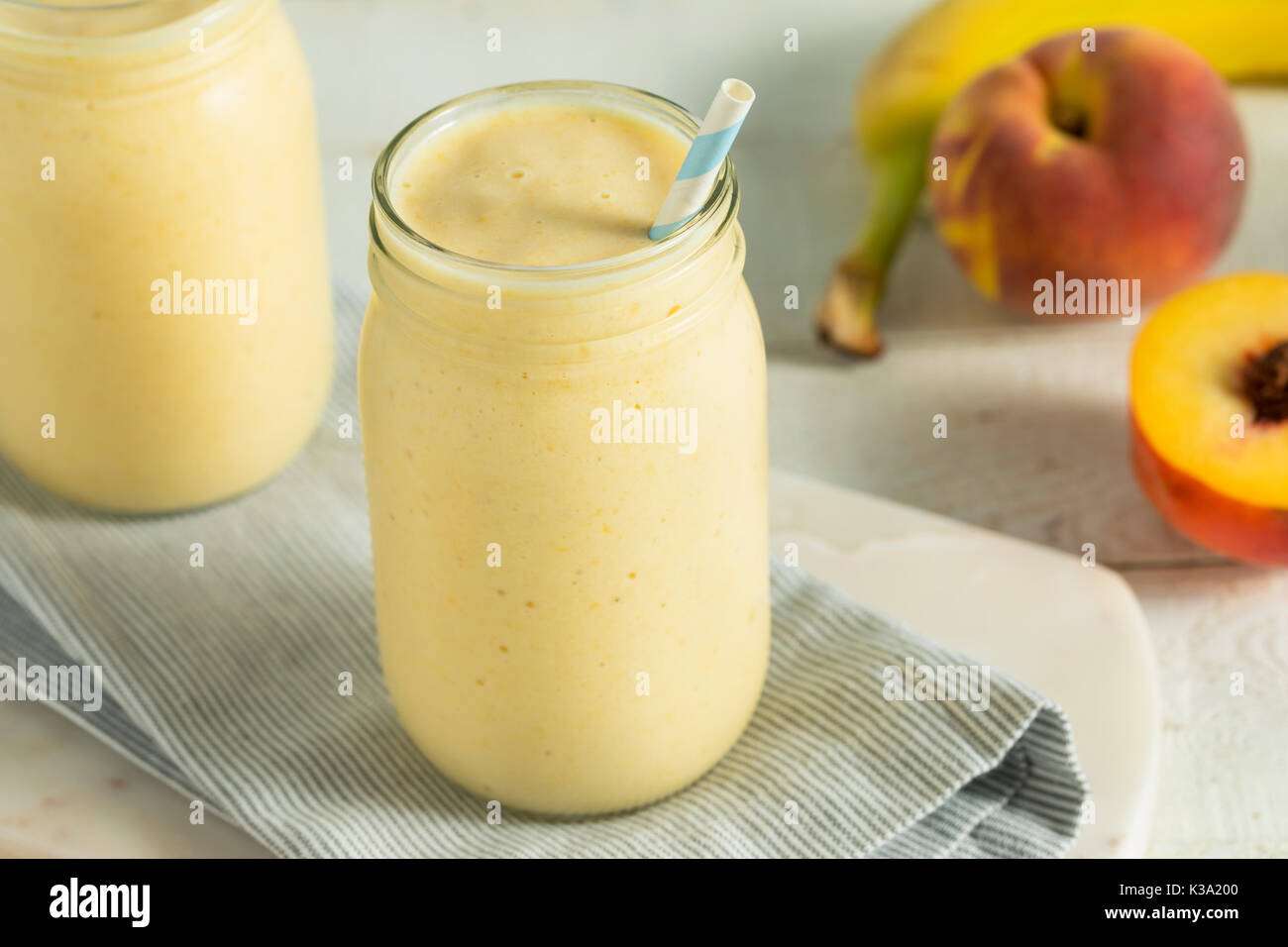 Healthy Homemade Peach Smoothie with Pineapple and Bananas Stock Photo