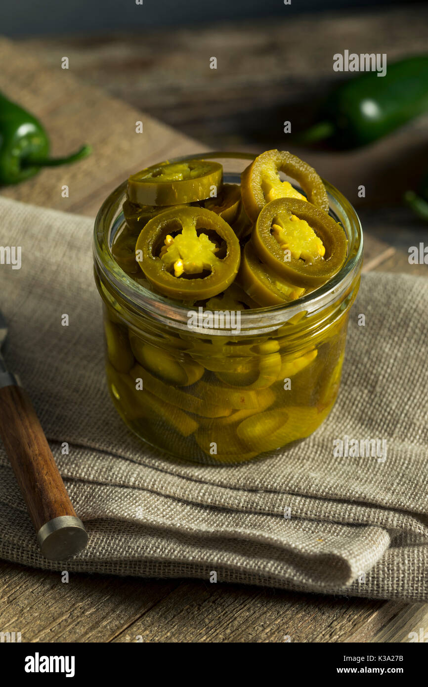 Green Organic Pickled Jalapenos in a Jar Stock Photo
