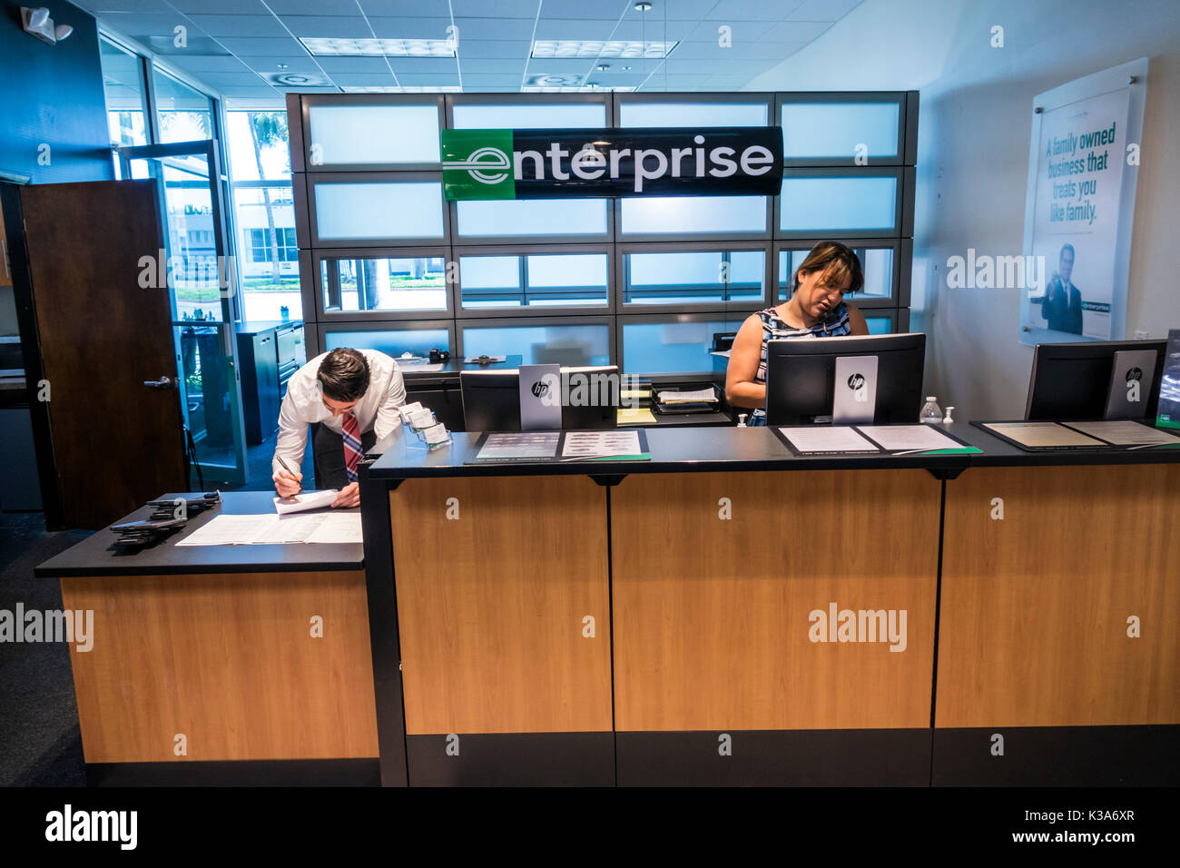 Miami Beach Florida,Enterprise,car cars rental,front counter desk,agent,interior inside,rent,adult adults man men male,woman women female lady,manager Stock Photo