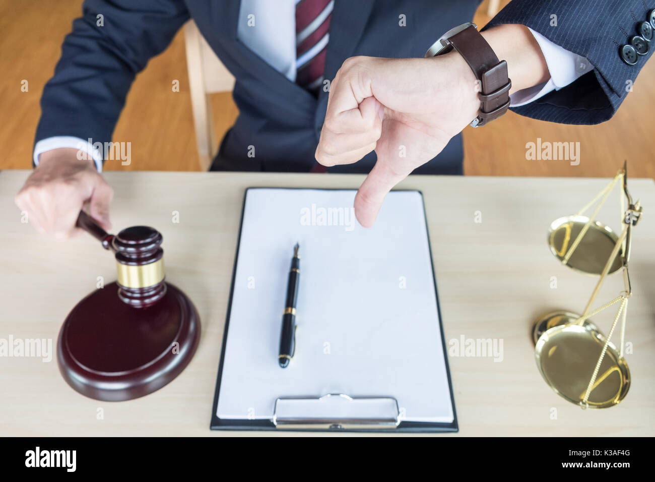 Law court or justice concept. Portrait lawyer making thumb down hand. Stock Photo