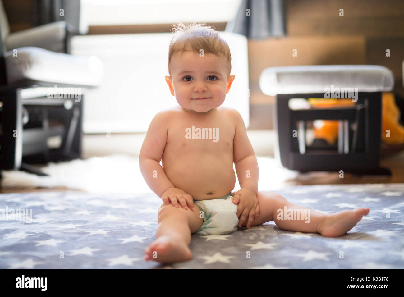 happy little baby boy sitting on floor at home Stock Photo - Alamy