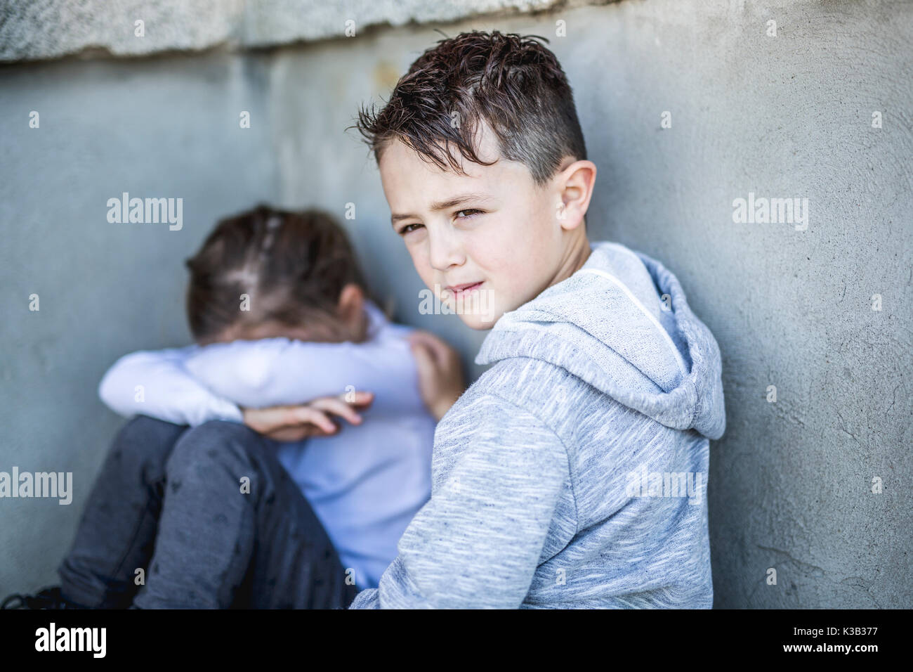 six years old sad school at the schoolyards Stock Photo