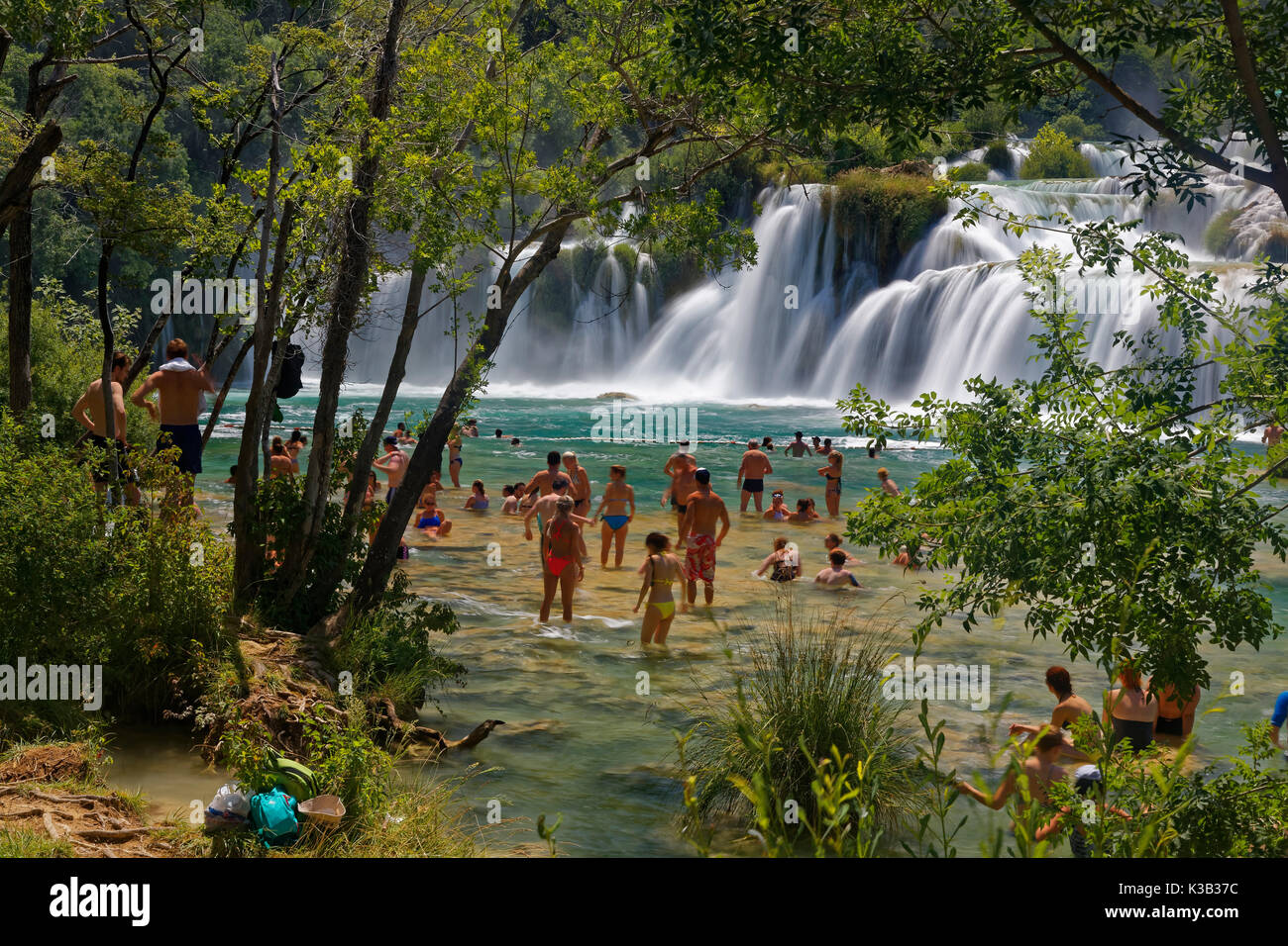 Tourists bathe at the waterfall Smotorcycleinski Buk, National Park Krka, Sibenik-Knin, Dalmatia, Croatia Stock Photo
