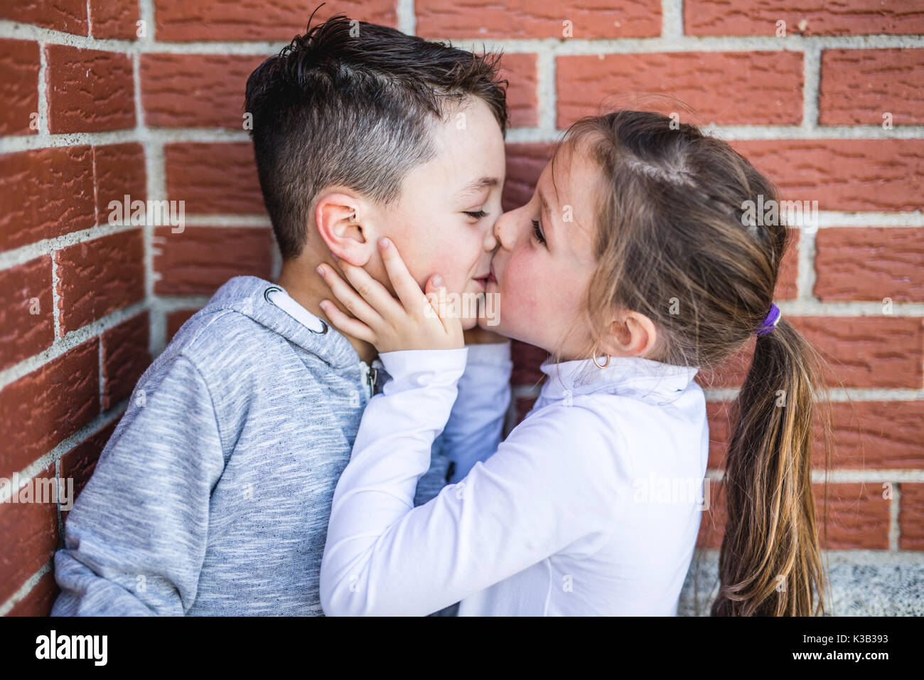 First love and kiss two happy cute kids meeting Stock Photo - Alamy
