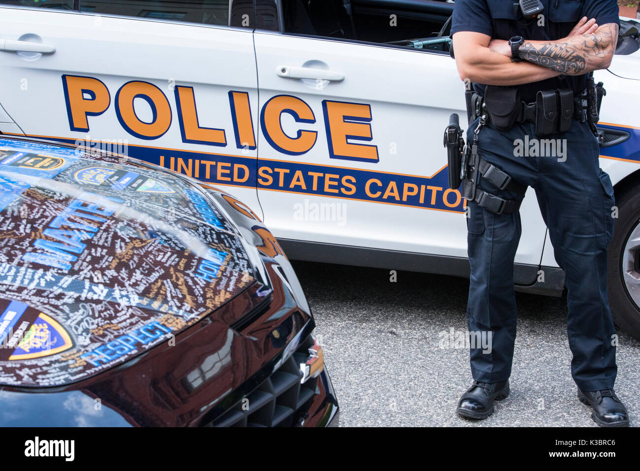 United States Capitol Police car with cop in full gear and pistol standing. Blue Lives Matter custom car hood with signatures to honor law enforcement Stock Photo