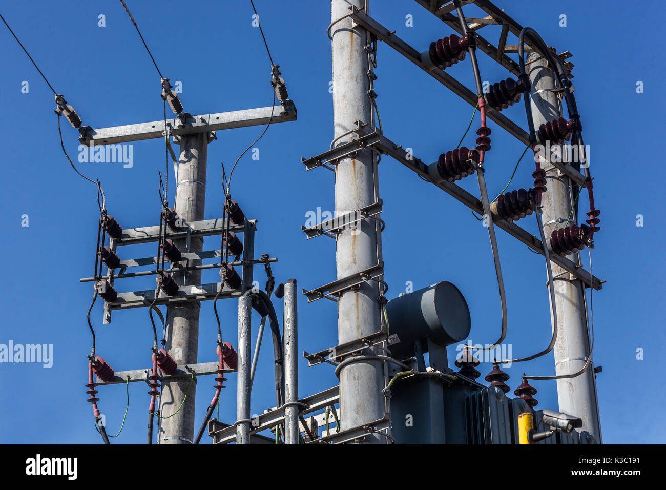 Power lines and Electrical power transformer in a rural setting Czech Republic Isolators Stock Photo
