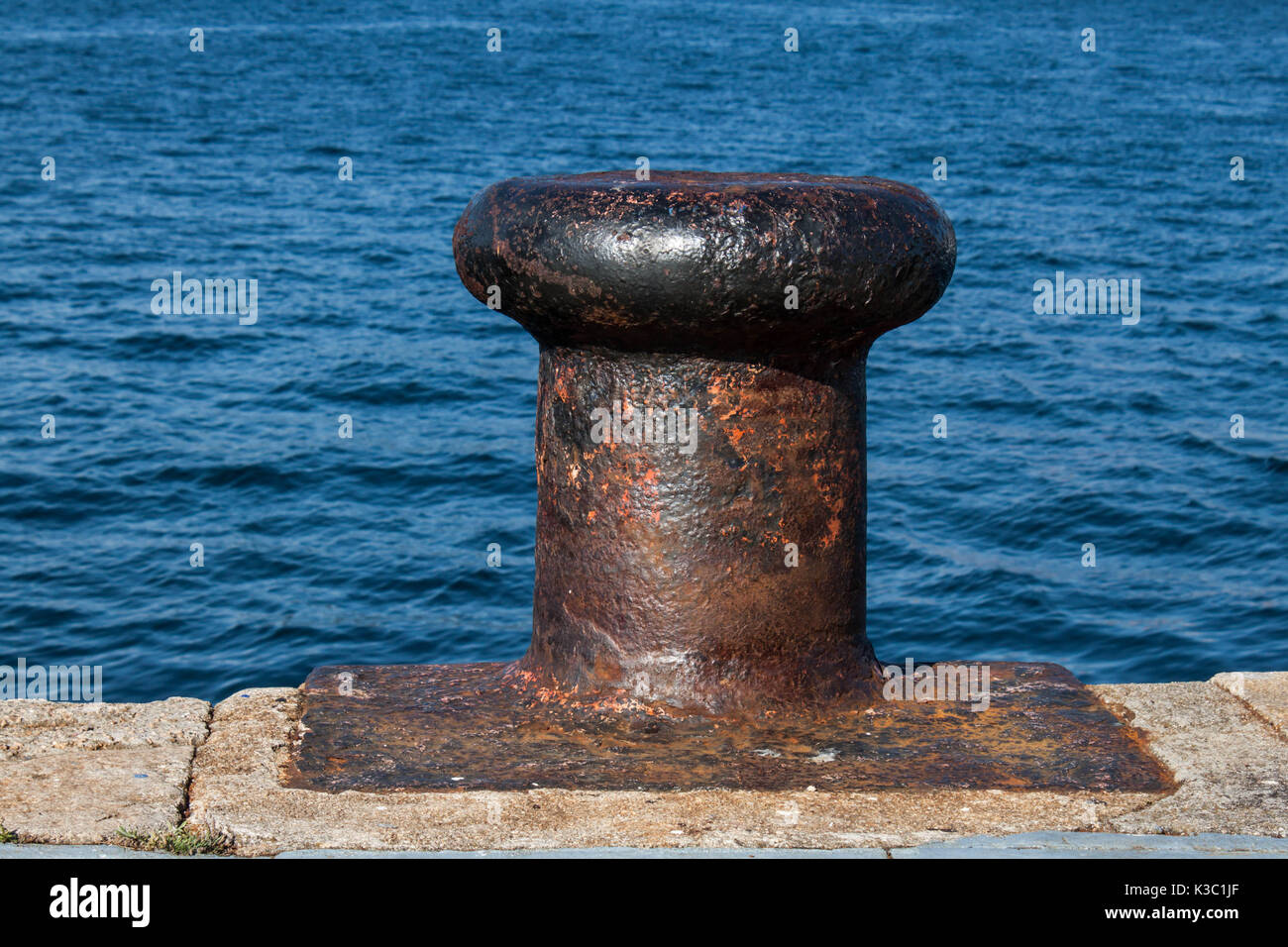 Iron mooring bollard  and sea background at the harbour in Vigo Spain Stock Photo