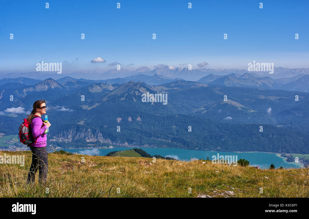 Woman with backpack in mountains Stock Photo
