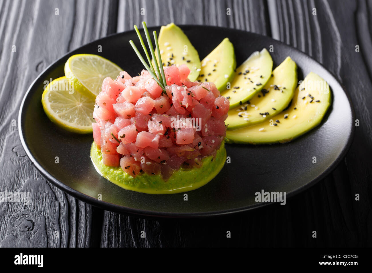 Beautiful food fresh tuna tartar with lime, avocado and sesame close