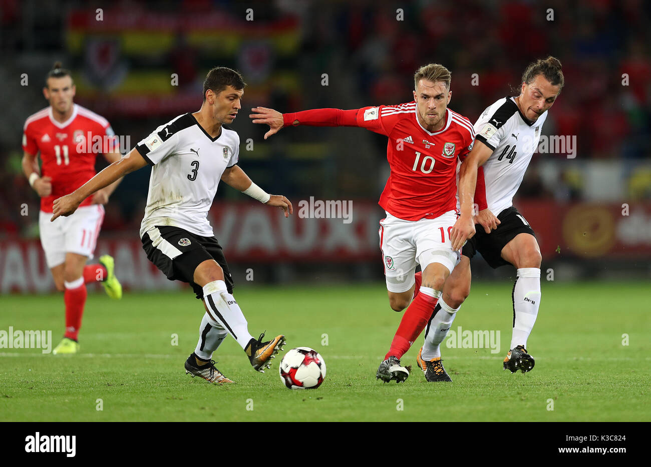 Wales' Aaron Ramsey (centre) in action with Austria's Aleksander Dragovic (left) and Julian Baumgartlinger during the 2018 FIFA World Cup Qualifying, Group D match at the Cardiff City Stadium. Stock Photo