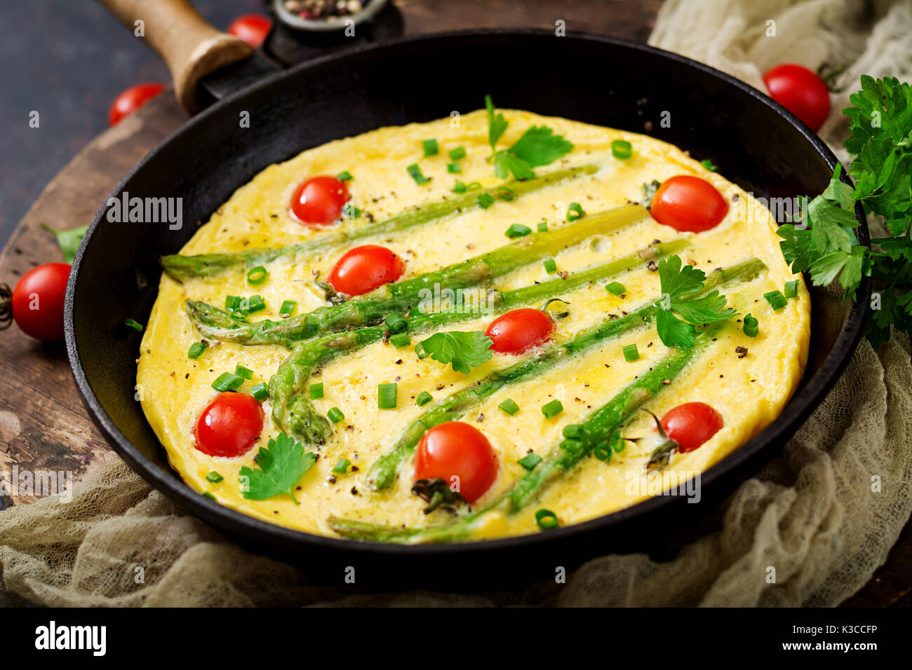 Omelette (omelet) with tomatoes, asparagus and green onions Stock Photo