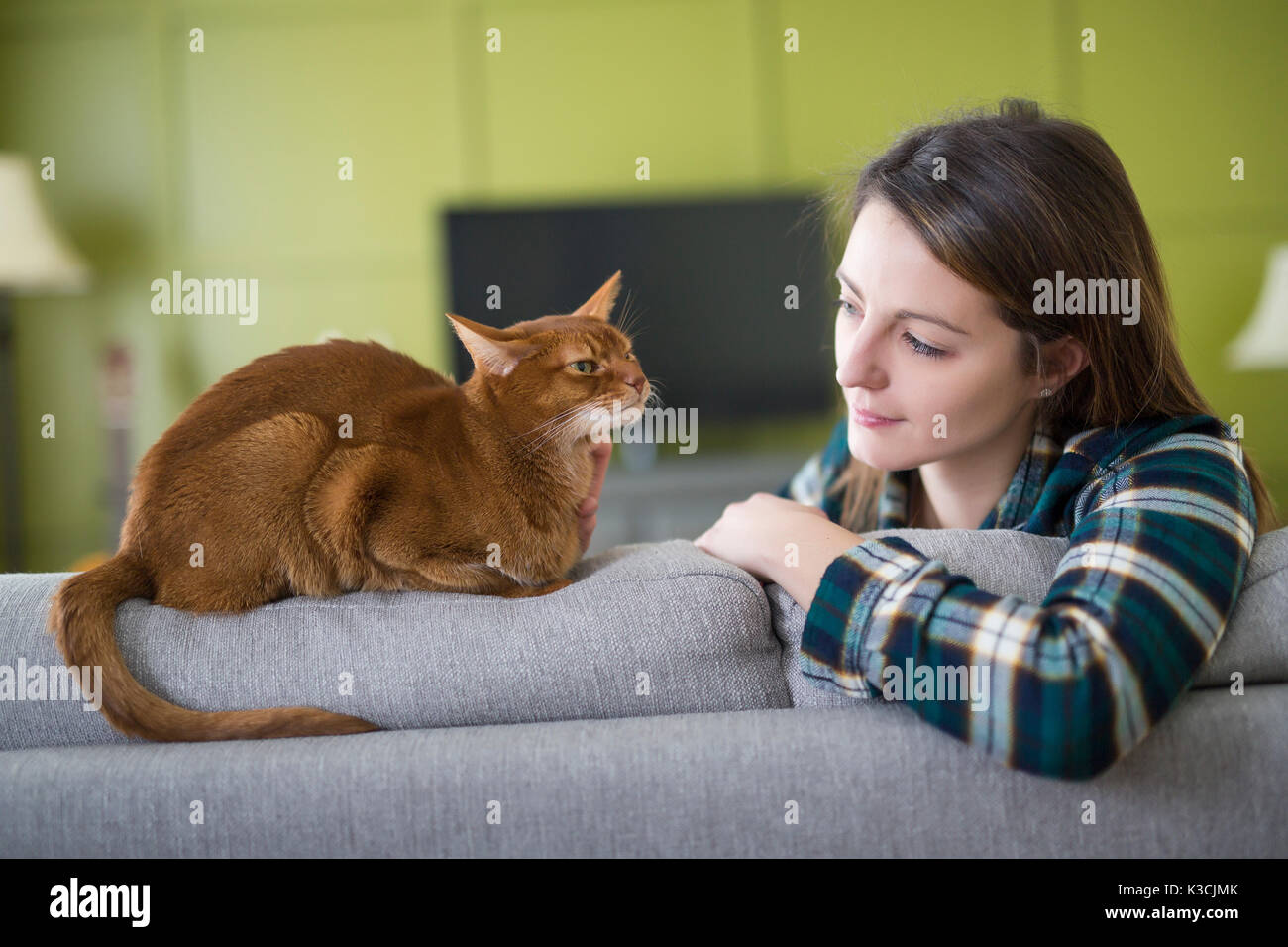 girl watching tv with cat Stock Photo