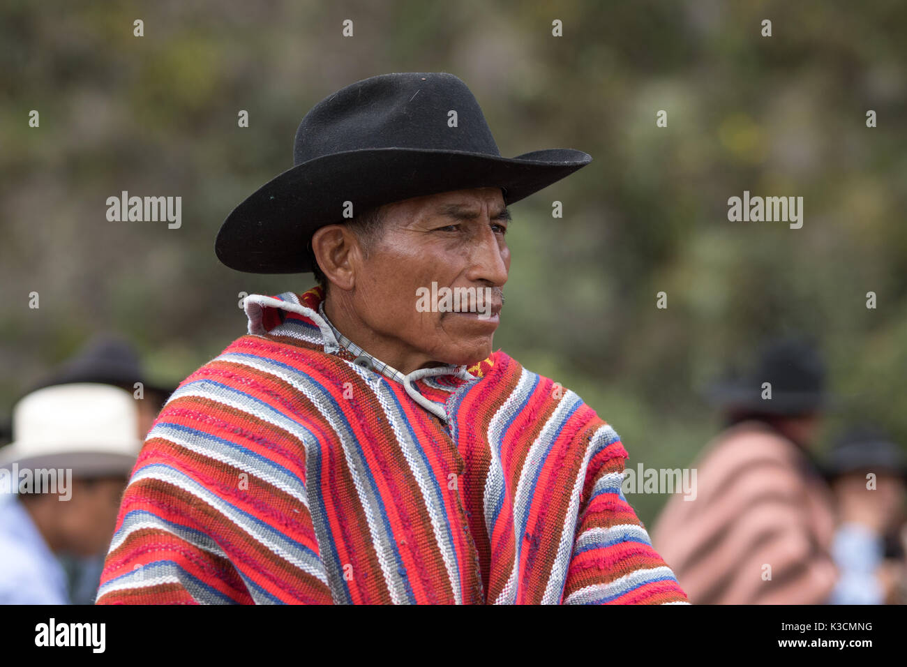 May 27, 2017 Sangolqui, Ecuador: closeup of a quechua cowboy wearing a traditionall wool poncho at a rural rodeo event in the Andes Stock Photo