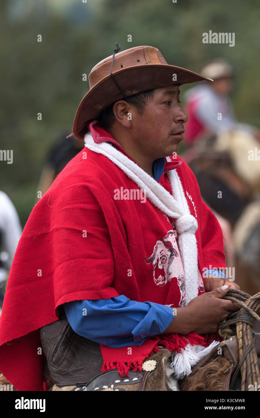 May 27, 2017 Sangolqui, Ecuador: closeup of a quechua cowboy wearing a traditionall wool poncho at a rural rodeo event in the Andes Stock Photo