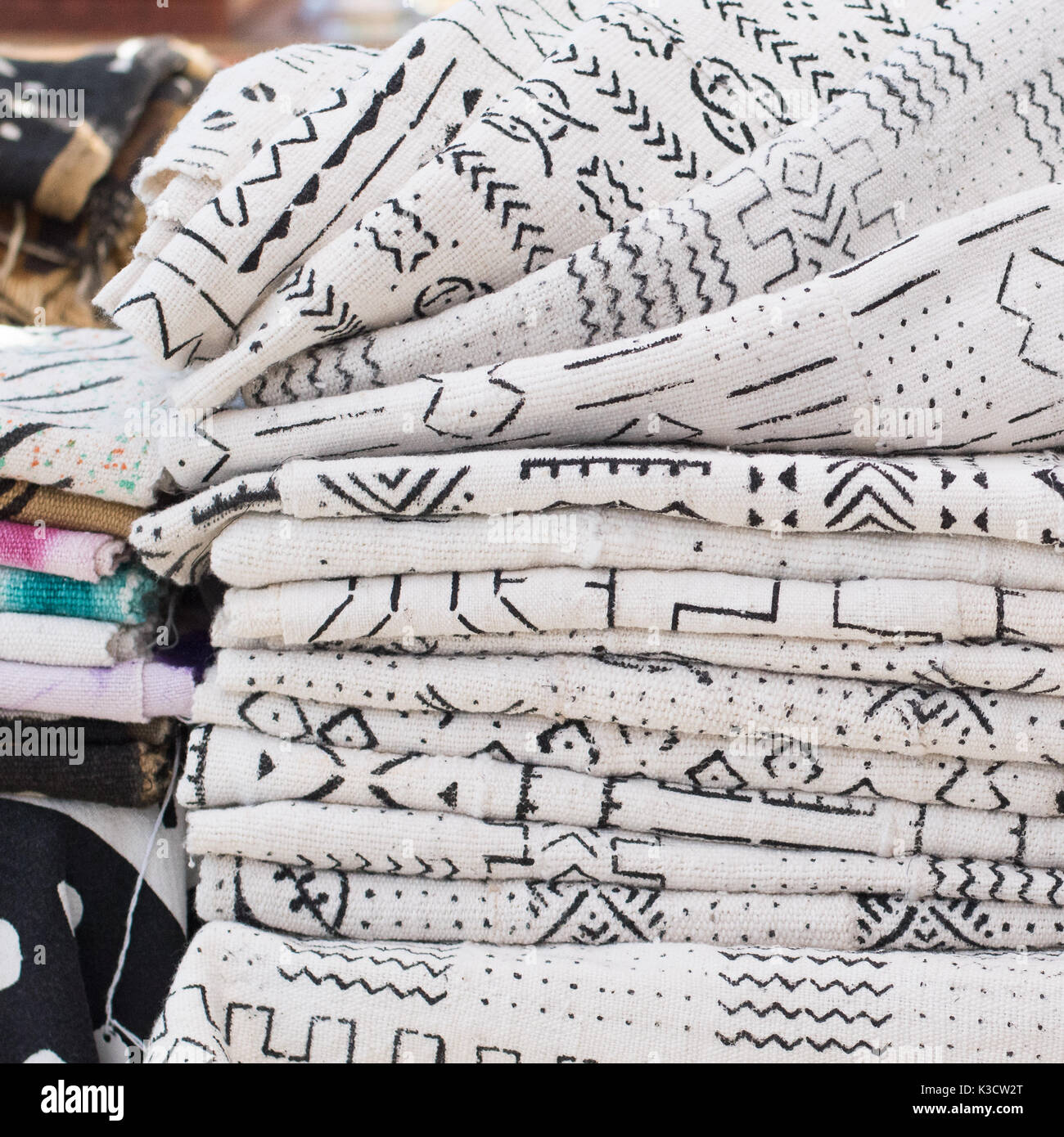 African textiles at a market stall featuring black and white patterns on hand-woven cloth by a woman from Ghana Stock Photo