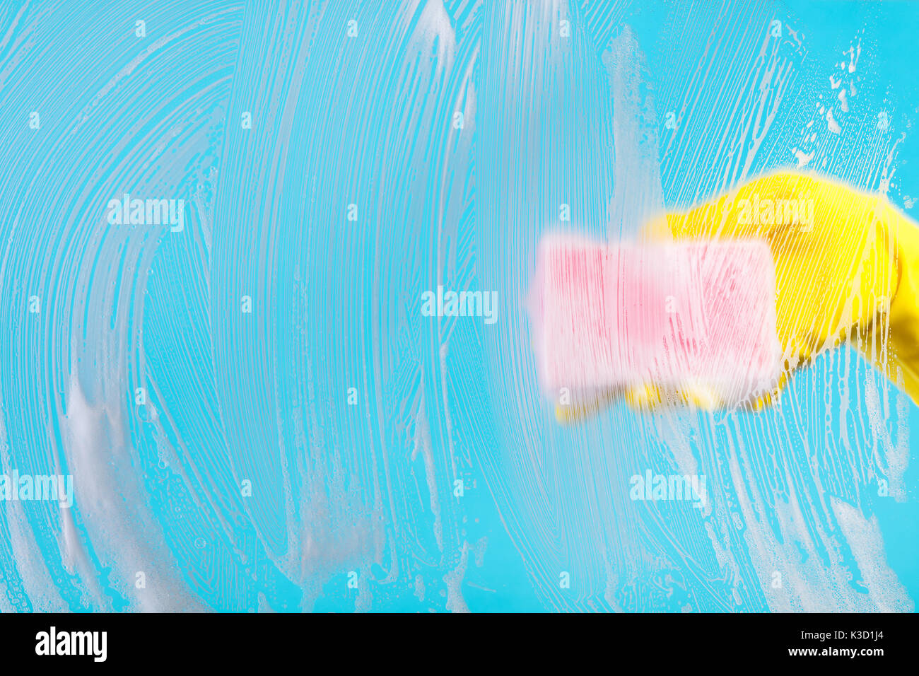 Glass Panel Sponge Clean Cleaning conept, hand cleaning glass window pane with detergent and ...