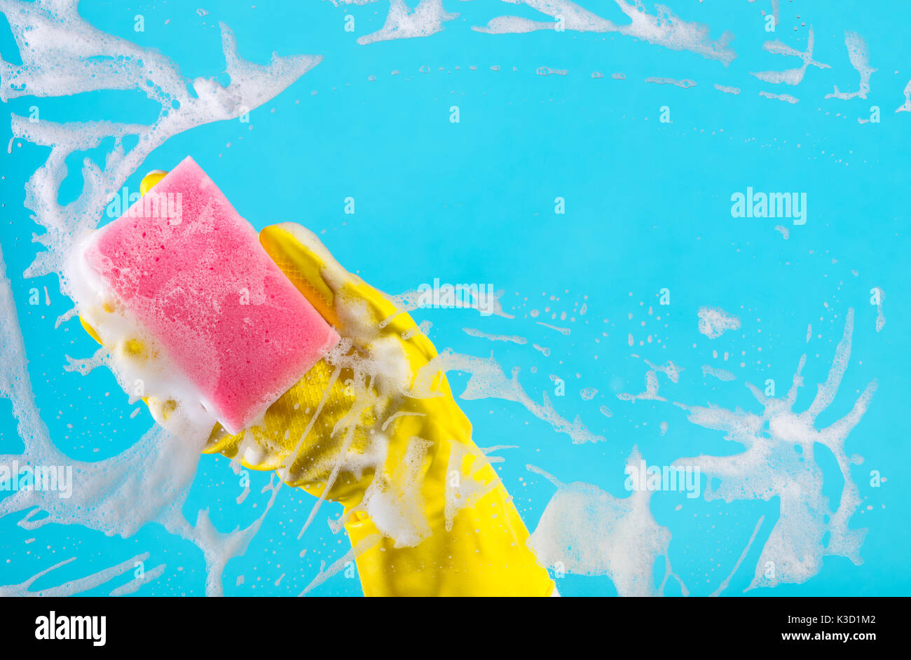 Cleaning conept, hand cleaning glass window pane with detergent and wipe or sponge Stock Photo