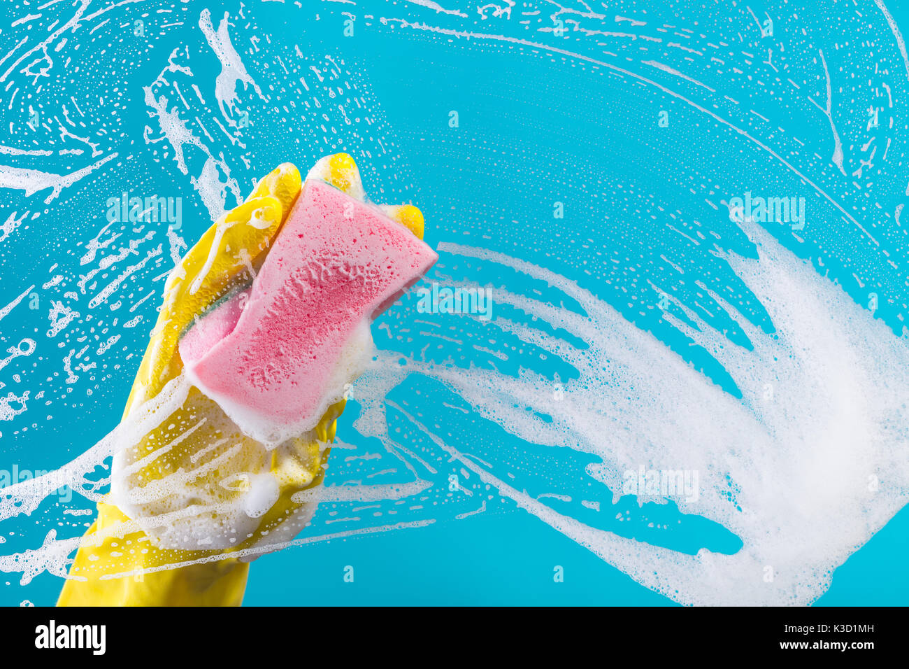 Glass Panel Sponge Clean Cleaning conept, hand cleaning glass window pane with detergent and ...