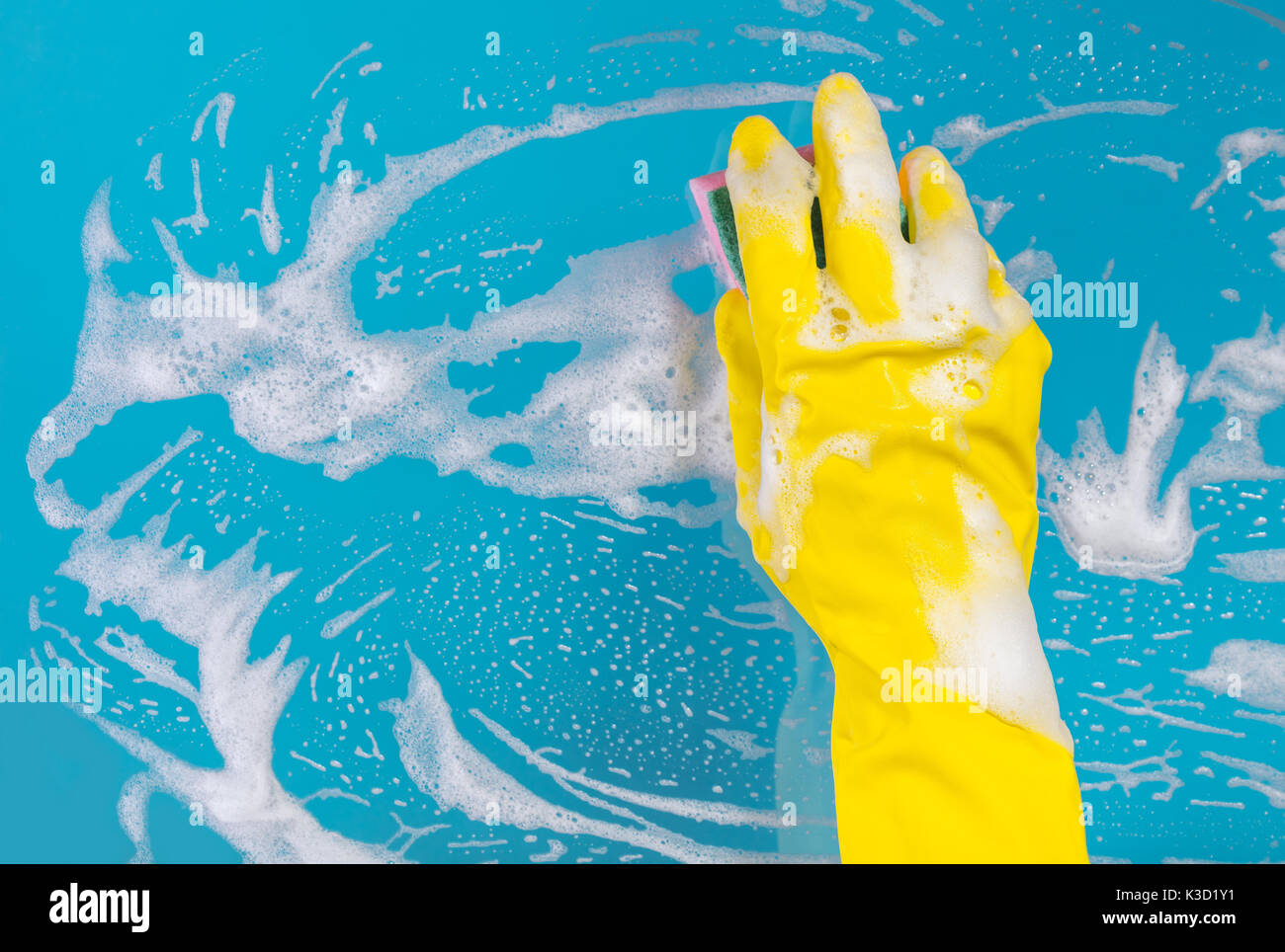 Glass Panel Sponge Clean Cleaning conept, hand cleaning glass window pane with detergent and ...