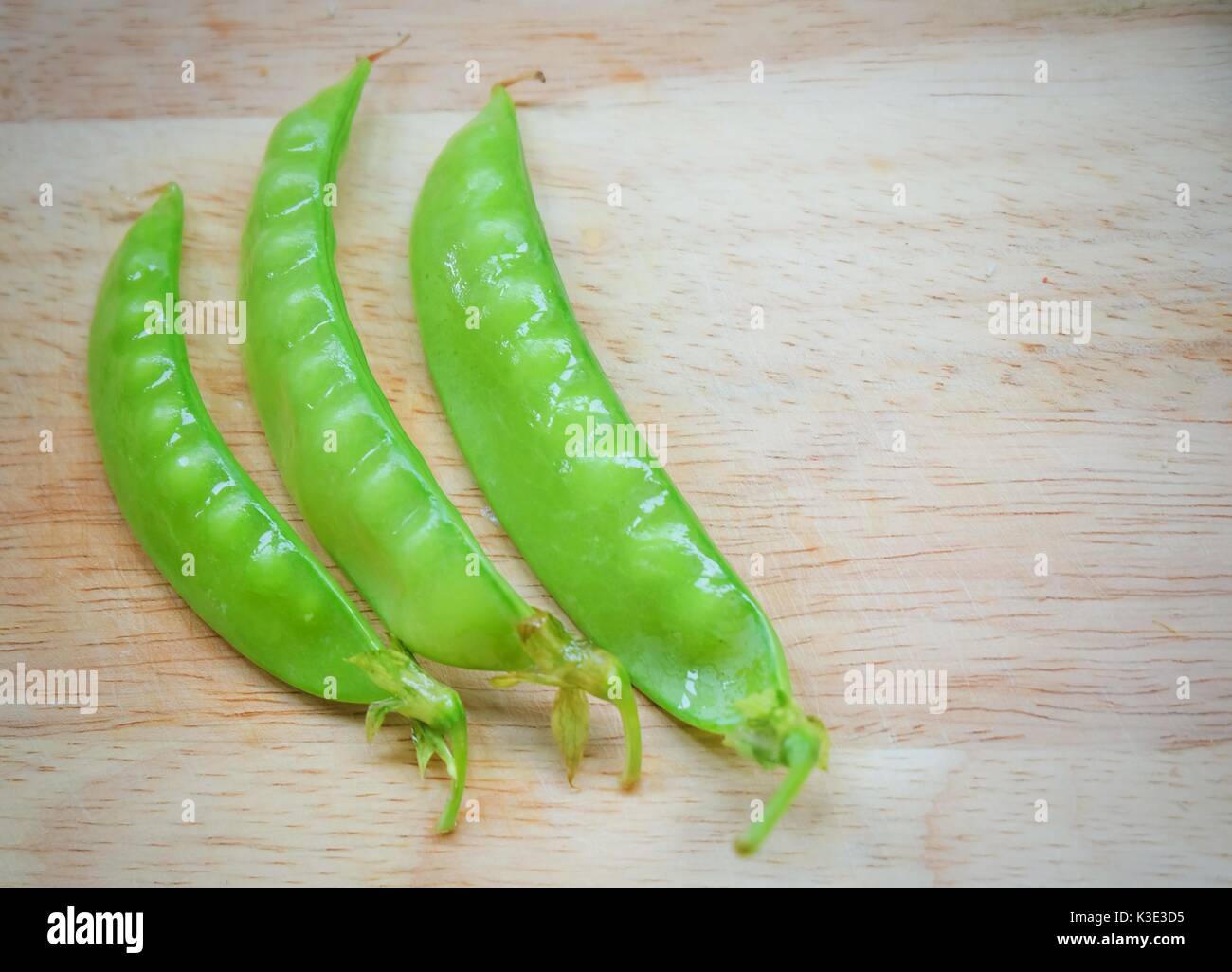 Vegetable Fresh Green Peas Pods On Cutting Board With Copy Space