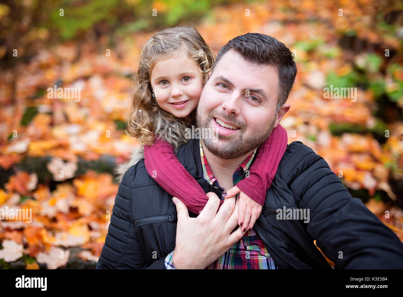 Little adorable girl with happy father in autumn park outdoors Stock ...
