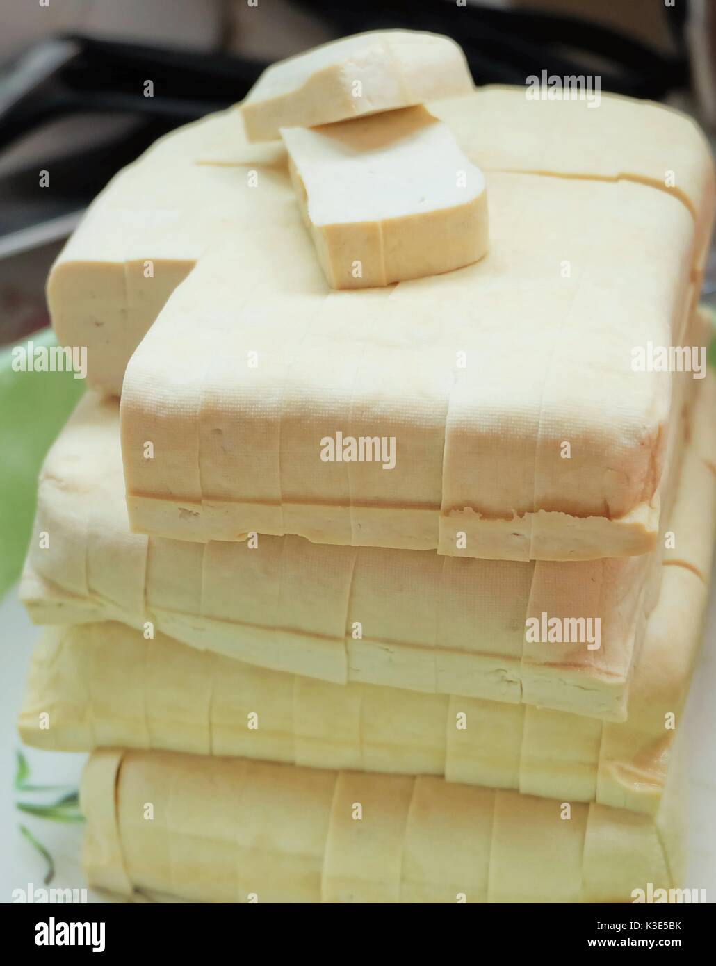 Firm Tofu on a Chopping Board with shape cutter Stock Photo - Alamy