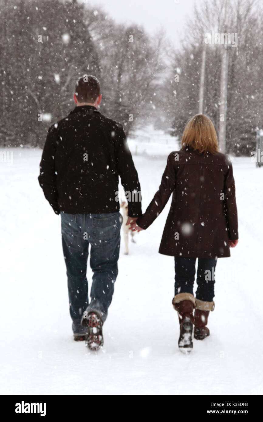 couple walking in winter wonderland Stock Photo