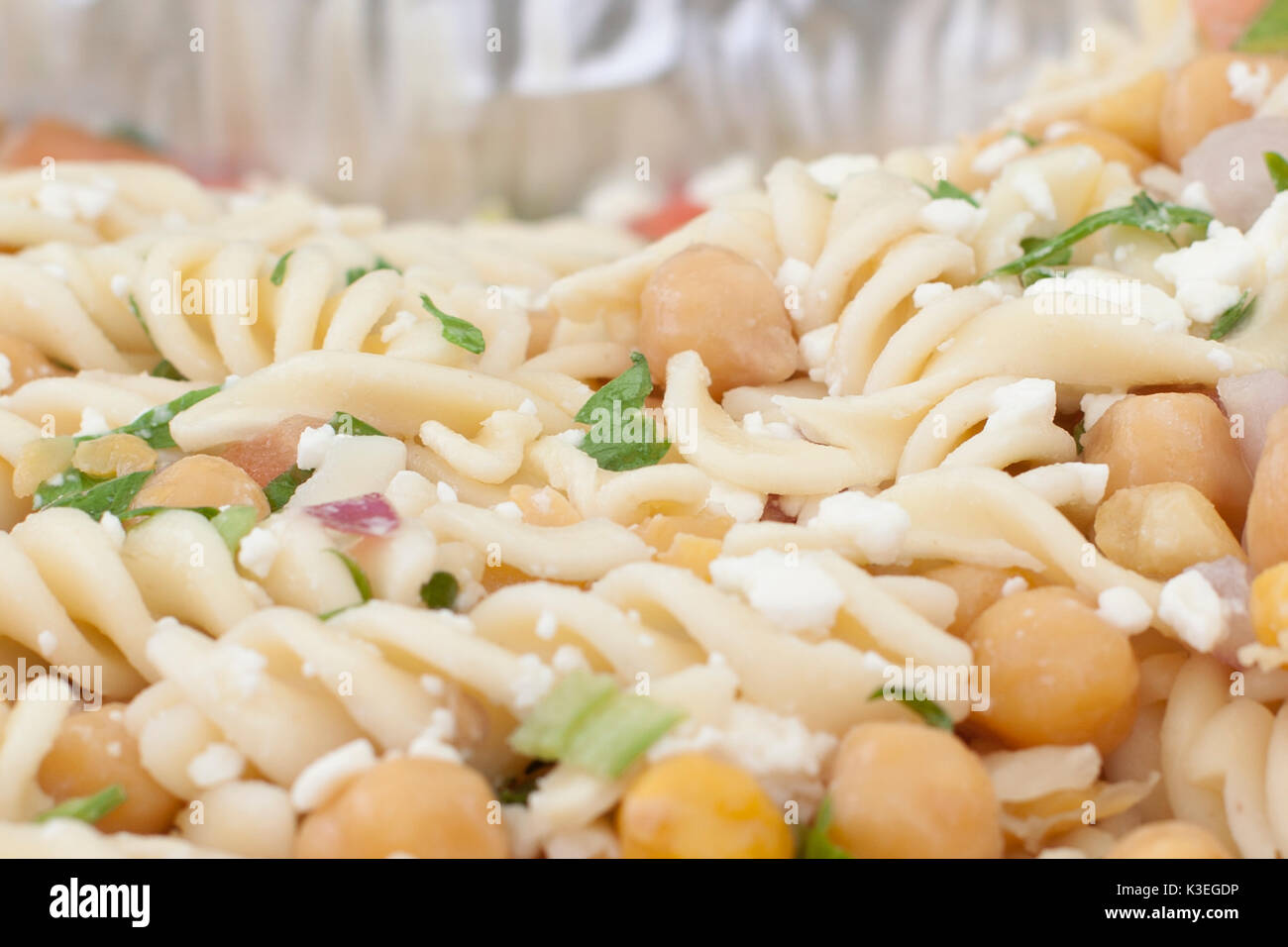 a close or macro view of fusilli or spiral pasta, food in a dish with