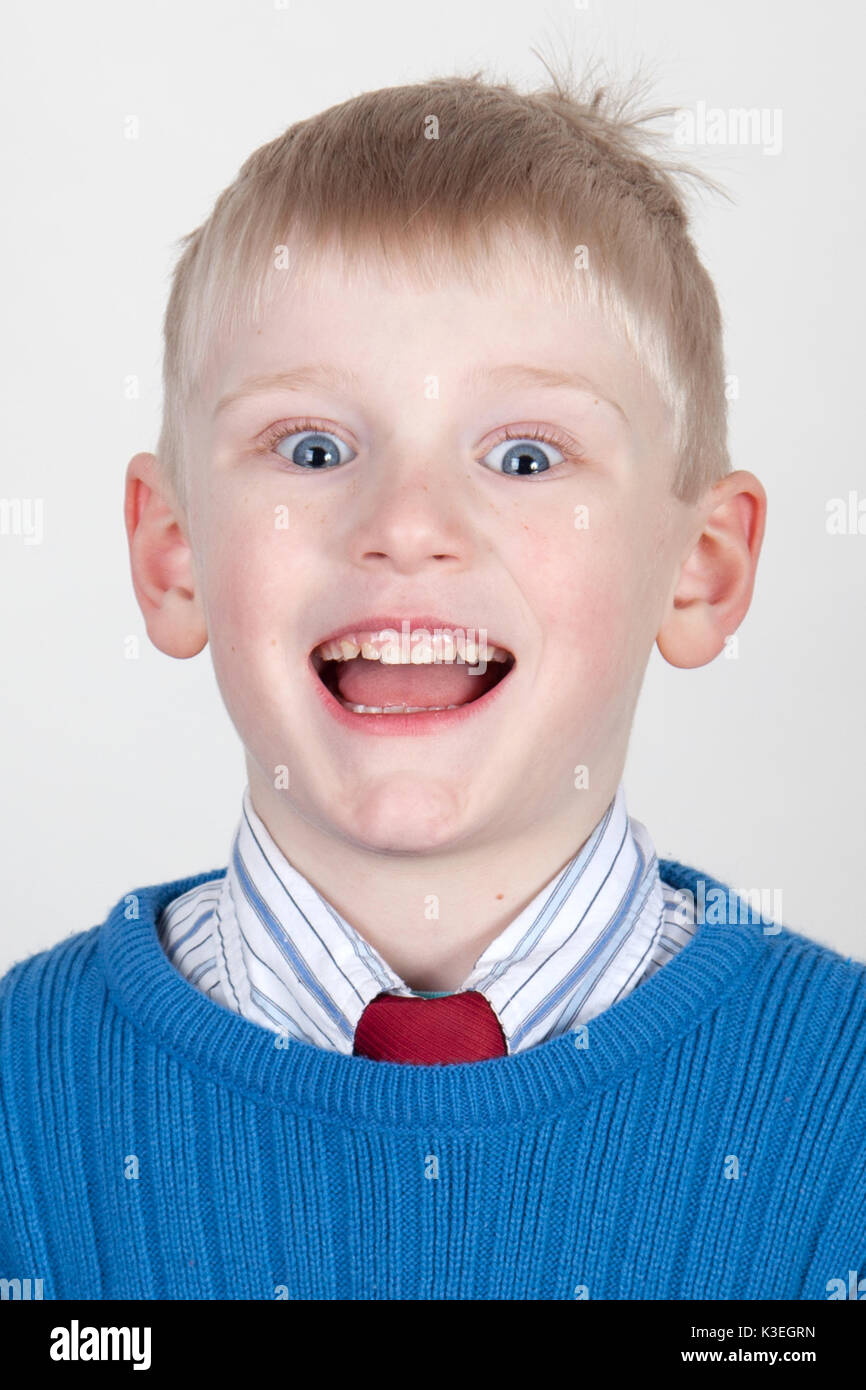 Wide eyed open mouthed smiling boy Stock Photo